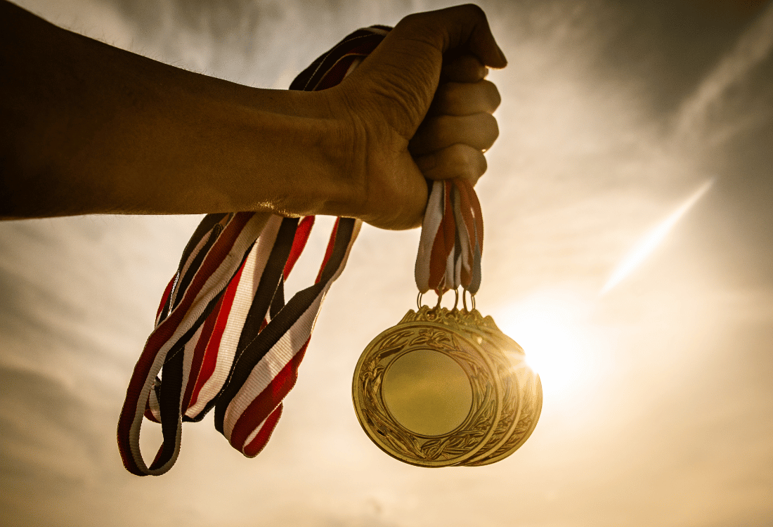 A olympian holding the medals they won in the Paris olympics.